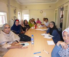 Women from many different cultures sitting at a table studying english