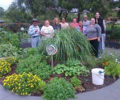 Lakemba Community Gardeners standing near the herb spiral that they built