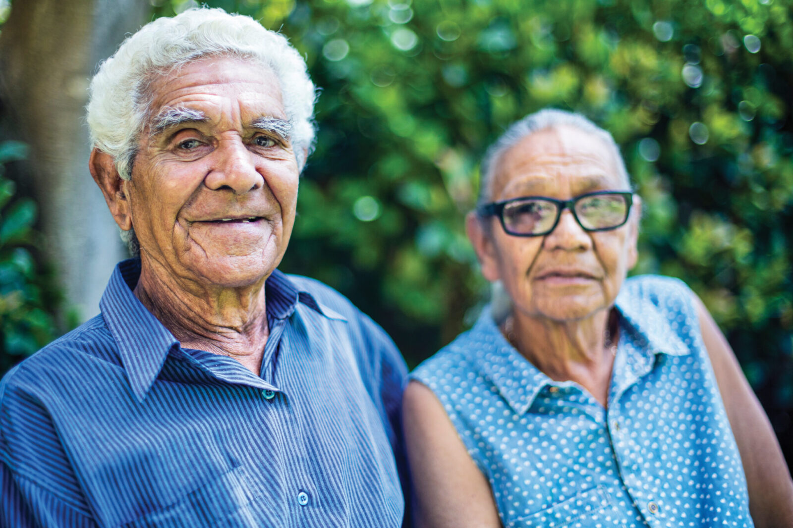 Portrait of a happy aboriginal senior couple relaxing in the backyard.