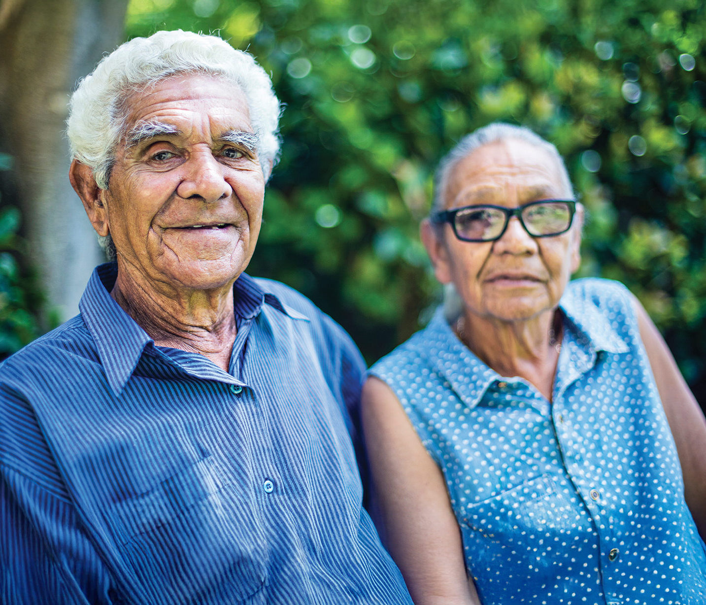 Portrait of a happy aboriginal senior couple relaxing in the backyard.